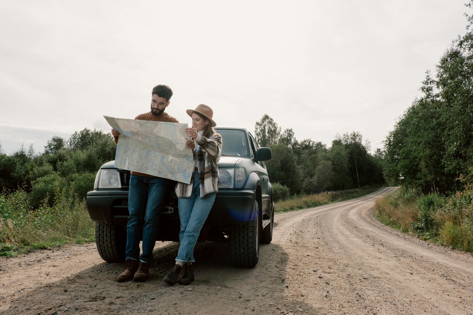 a couple on a road trip looking at a map